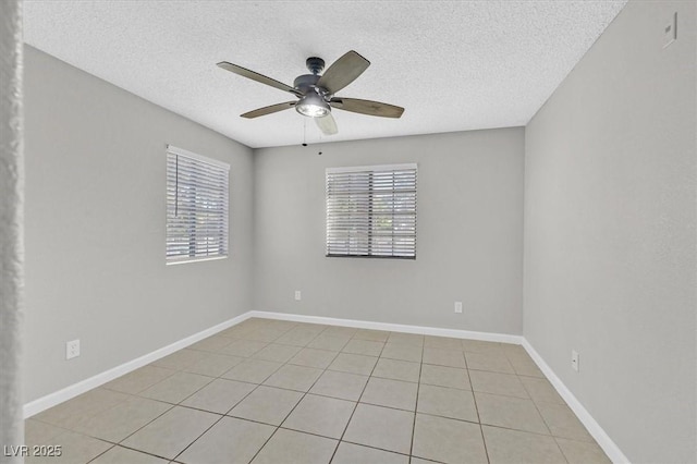 230 Mission Newport Ln Unit 104, Las Vegas, NV 89107 - unfurnished room with a textured ceiling, ceiling fan, light tile patterned flooring, and baseboards
