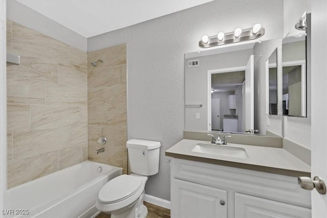 230 Mission Newport Ln Unit 104, Las Vegas, NV 89107 - full bath featuring a textured wall, toilet, vanity, bathing tub / shower combination, and baseboards