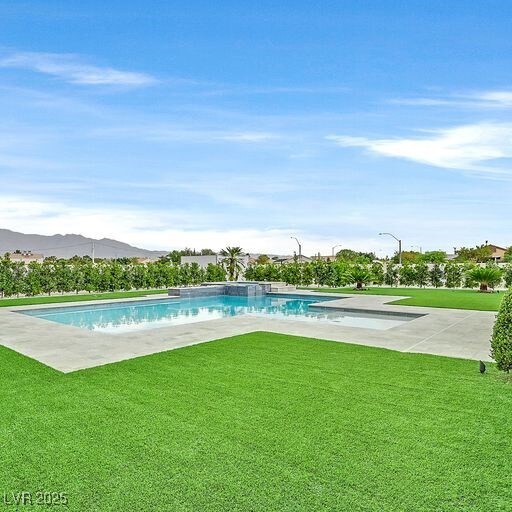 5400 Mello Ave, Las Vegas, NV 89131 - outdoor pool featuring a yard, a mountain view, and a patio area