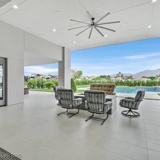 5400 Mello Ave, Las Vegas, NV 89131 - view of patio / terrace with a ceiling fan, a mountain view, an infinity pool, and an outdoor hangout area