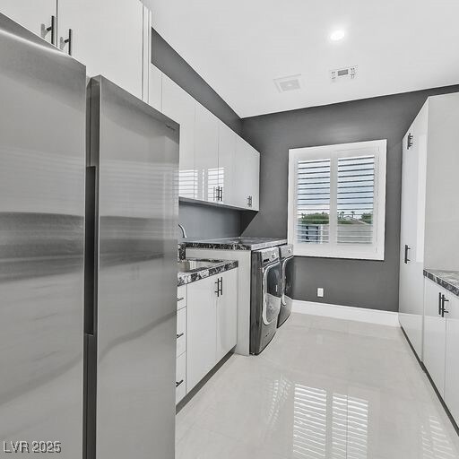 5400 Mello Ave, Las Vegas, NV 89131 - laundry area featuring washer and clothes dryer, cabinet space, light tile patterned flooring, and recessed lighting
