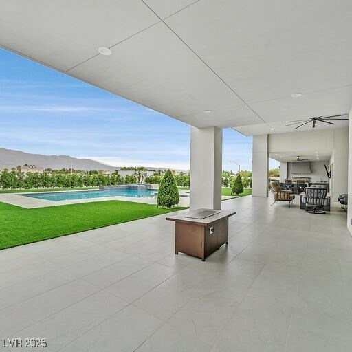 5400 Mello Ave, Las Vegas, NV 89131 - view of patio featuring an outdoor pool, an outdoor kitchen, and a mountain view