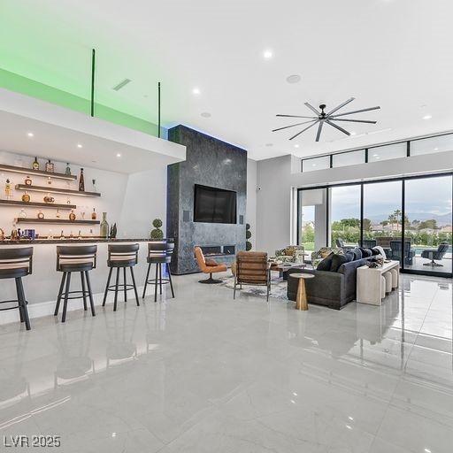 5400 Mello Ave, Las Vegas, NV 89131 - living room featuring wet bar, a high end fireplace, recessed lighting, and a towering ceiling