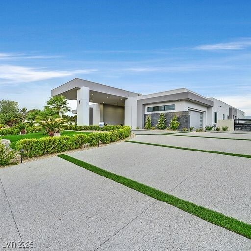 5400 Mello Ave, Las Vegas, NV 89131 - contemporary house featuring stucco siding, concrete driveway, and a garage