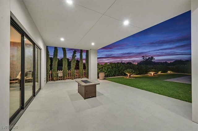 5400 Mello Ave, Las Vegas, NV 89131 - patio terrace at dusk with a fire pit, a patio, and a yard