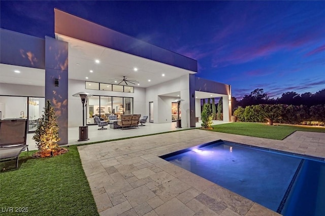 5400 Mello Ave, Las Vegas, NV 89131 - pool at dusk featuring ceiling fan, a patio, a yard, and an outdoor pool