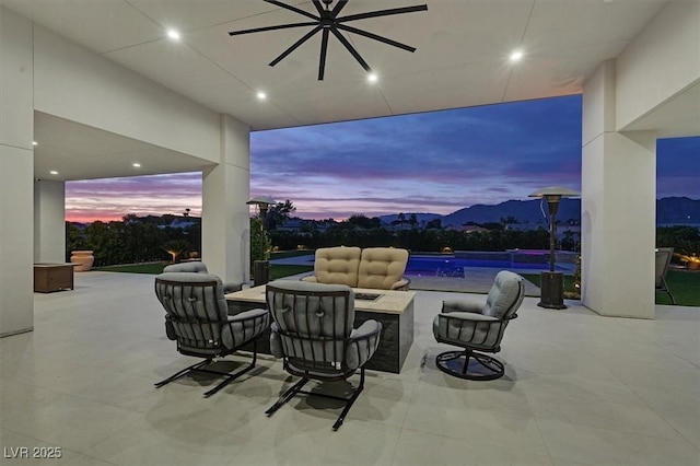 5400 Mello Ave, Las Vegas, NV 89131 - patio terrace at dusk with ceiling fan, an infinity pool, a patio area, and an outdoor fire pit