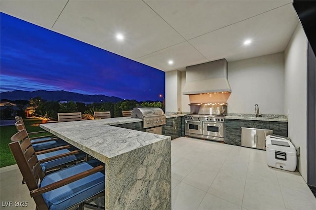 5400 Mello Ave, Las Vegas, NV 89131 - patio terrace at dusk featuring area for grilling, a mountain view, and a patio area