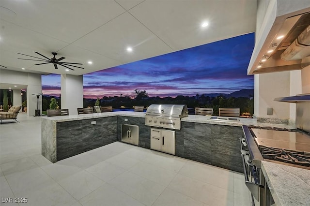 5400 Mello Ave, Las Vegas, NV 89131 - patio terrace at dusk featuring exterior kitchen, a patio, and a ceiling fan