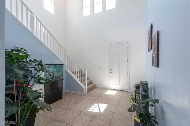 754 Tallgrass St, Las Vegas, NV 89138 - entryway featuring a high ceiling, stairway, light tile patterned floors, and baseboards