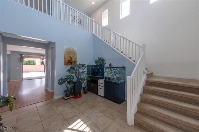754 Tallgrass St, Las Vegas, NV 89138 - stairs featuring a high ceiling, tile patterned floors, and baseboards