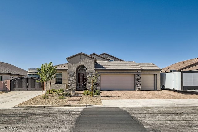 130 W Fairway Rd, Henderson, NV 89015 - view of front of home featuring a gate, an attached garage, stucco siding, and driveway