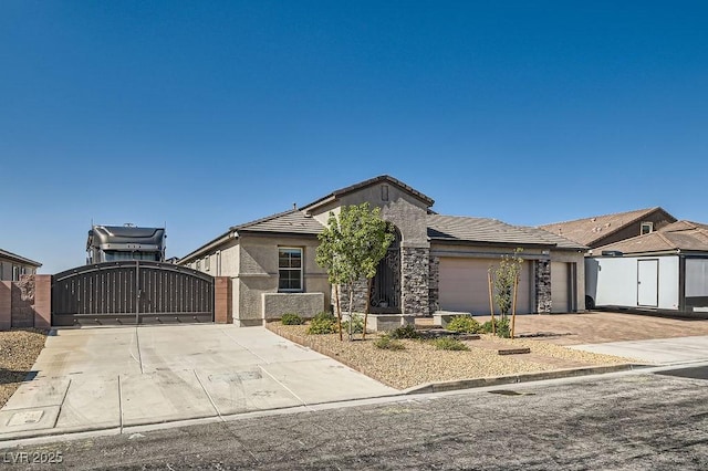130 W Fairway Rd, Henderson, NV 89015 - view of front of home featuring a gate, concrete driveway, an attached garage, stucco siding, and a tiled roof