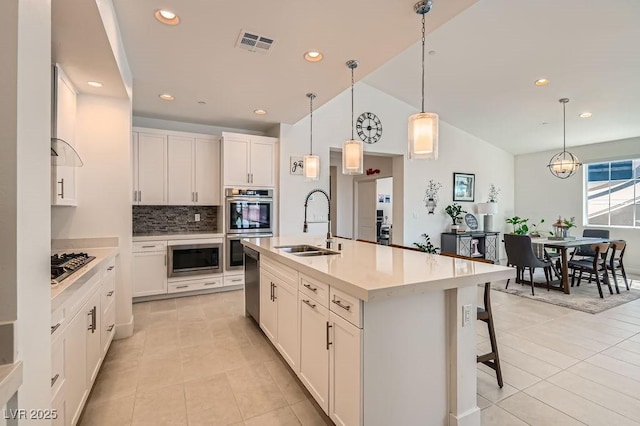 130 W Fairway Rd, Henderson, NV 89015 - kitchen featuring a sink, stainless steel appliances, light tile patterned floors, decorative backsplash, and lofted ceiling