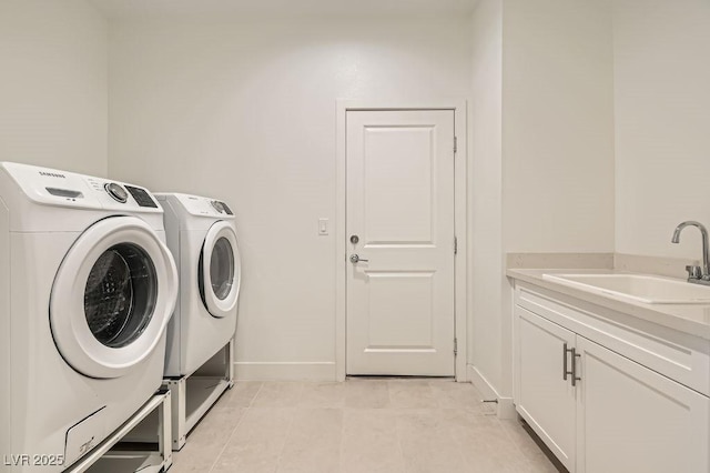 130 W Fairway Rd, Henderson, NV 89015 - laundry area with washer and clothes dryer, cabinet space, baseboards, and light tile patterned flooring