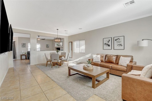 10988 Salernes St, Las Vegas, NV 89141 - living room with light tile patterned floors, crown molding, ceiling fan, and baseboards