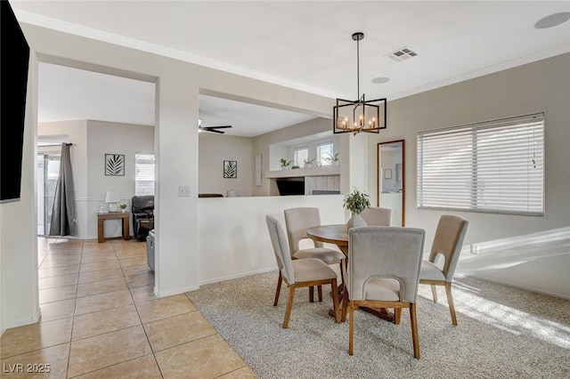 10988 Salernes St, Las Vegas, NV 89141 - dining area featuring light tile patterned flooring, a chandelier, ornamental molding, baseboards, and a ceiling fan