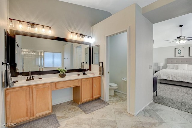 10988 Salernes St, Las Vegas, NV 89141 - ensuite bathroom featuring double vanity, ceiling fan, toilet, a shower stall, and baseboards