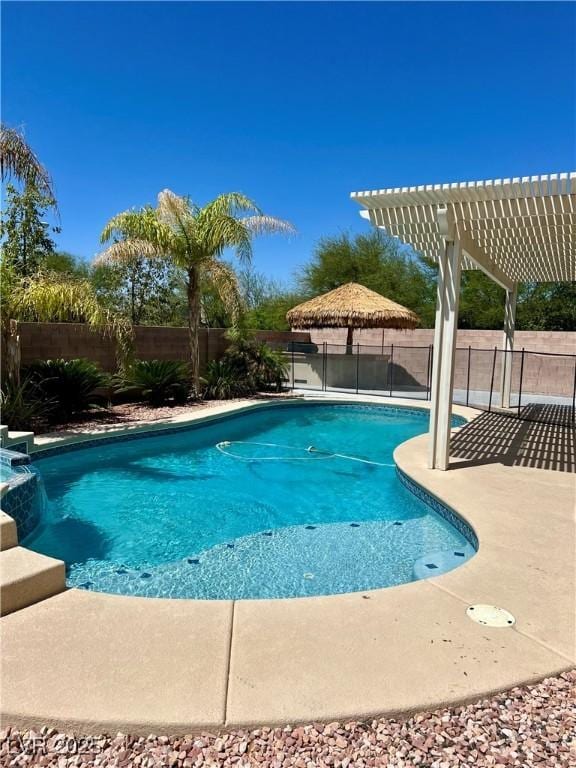 1921 Moonlight Bluff Ave, North Las Vegas, NV 89084 - view of pool with a pergola, a fenced backyard, and a pool with connected hot tub