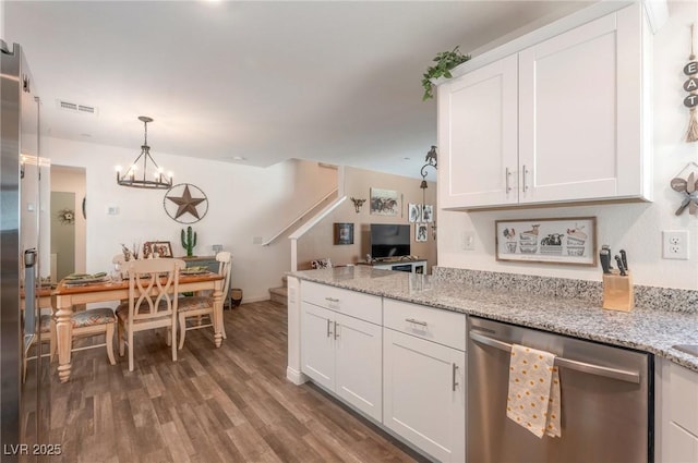 12348 Golden Wreath Rd Unit 1, Las Vegas, NV 89183 - kitchen with stainless steel dishwasher, white cabinets, wood finished floors, pendant lighting, and light stone countertops