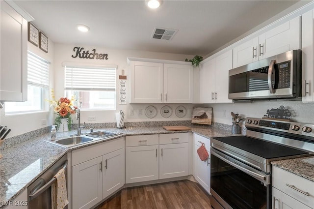 12348 Golden Wreath Rd Unit 1, Las Vegas, NV 89183 - kitchen with stainless steel appliances, a sink, white cabinets, dark wood-style floors, and recessed lighting