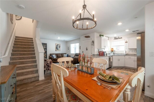 12348 Golden Wreath Rd Unit 1, Las Vegas, NV 89183 - dining room featuring wood finished floors, a chandelier, stairway, baseboards, and recessed lighting
