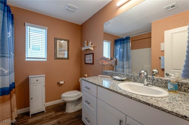 12348 Golden Wreath Rd Unit 1, Las Vegas, NV 89183 - bathroom with toilet, vanity, wood finished floors, and plenty of natural light