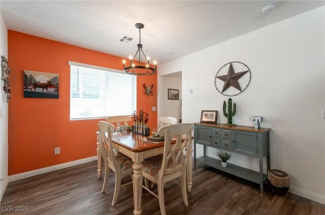 12348 Golden Wreath Rd Unit 1, Las Vegas, NV 89183 - dining space featuring a chandelier, dark wood-style flooring, and baseboards