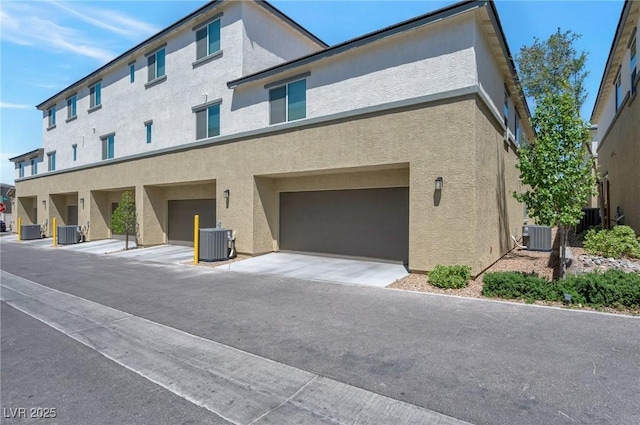 12348 Golden Wreath Rd Unit 1, Las Vegas, NV 89183 - back of house featuring cooling unit, stucco siding, and an attached garage
