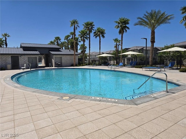 12348 Golden Wreath Rd Unit 1, Las Vegas, NV 89183 - community pool featuring a patio area and a residential view
