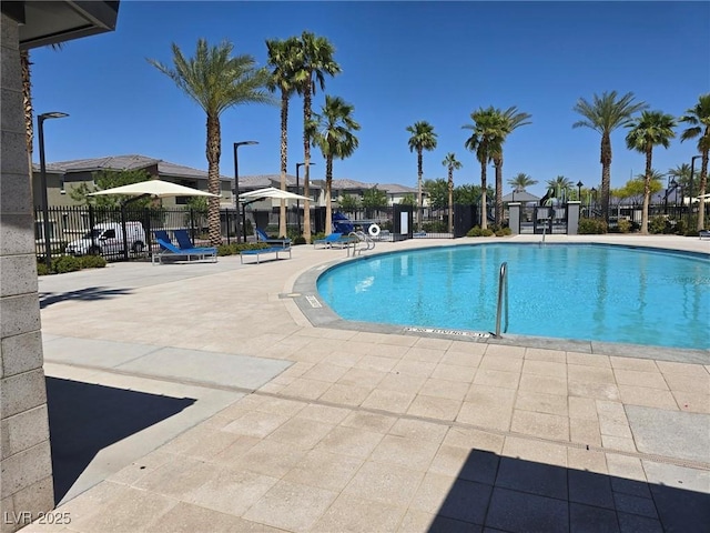 12348 Golden Wreath Rd Unit 1, Las Vegas, NV 89183 - community pool featuring a patio area and a residential view