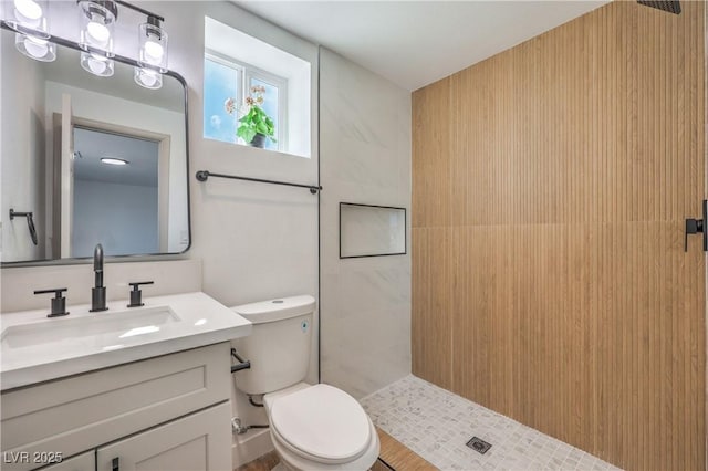 5200 Blanton Dr, Las Vegas, NV 89122 - bathroom featuring toilet, tiled shower, and vanity