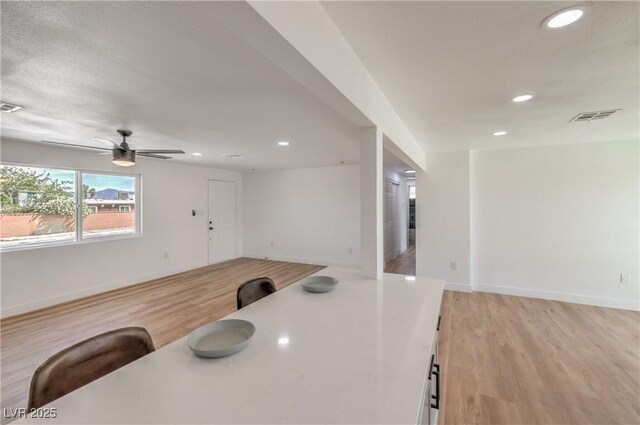 5200 Blanton Dr, Las Vegas, NV 89122 - kitchen with open floor plan, recessed lighting, light wood-style flooring, baseboards, and ceiling fan
