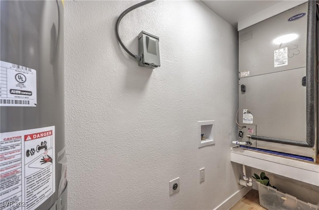 5200 Blanton Dr, Las Vegas, NV 89122 - washroom with water heater, hookup for a washing machine, wood finished floors, hookup for an electric dryer, and baseboards