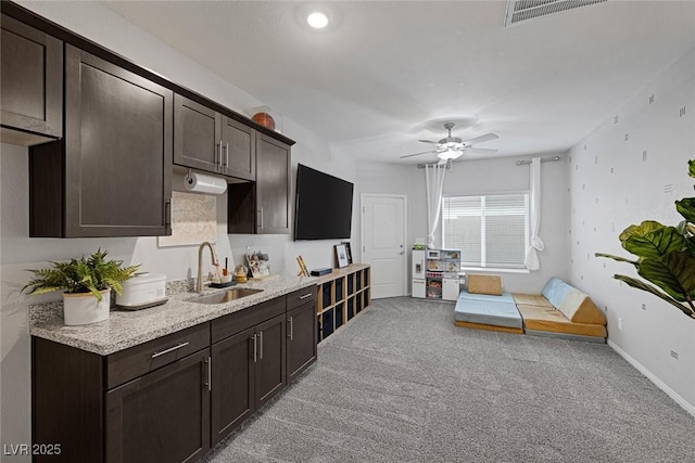 5234 Savannah Rose St, Las Vegas, NV 89149 - kitchen with a sink, dark brown cabinetry, and light carpet