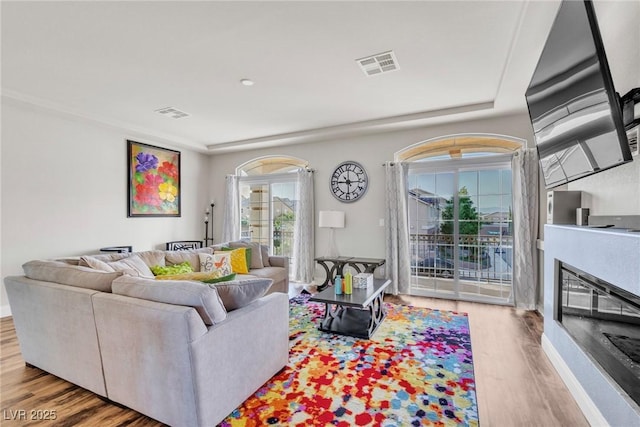 5889 Thistle Meadow Ave, Las Vegas, NV 89139 - living room featuring wood finished floors and a glass covered fireplace