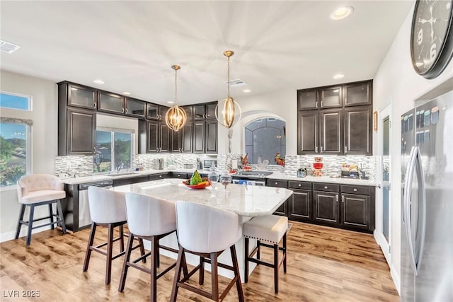 5889 Thistle Meadow Ave, Las Vegas, NV 89139 - kitchen with stainless steel appliances, plenty of natural light, a breakfast bar, and recessed lighting