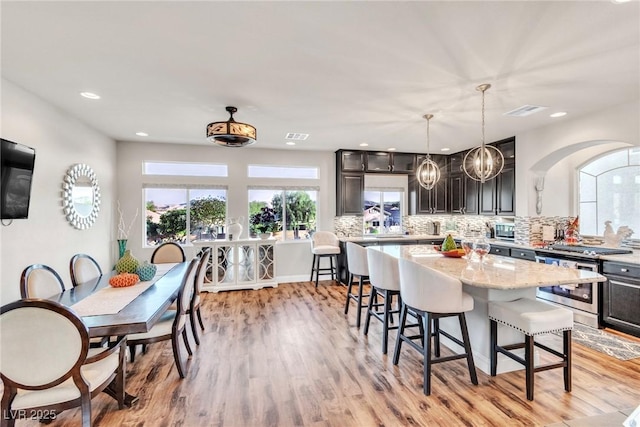 5889 Thistle Meadow Ave, Las Vegas, NV 89139 - kitchen featuring gas range, a breakfast bar, backsplash, a center island, and recessed lighting