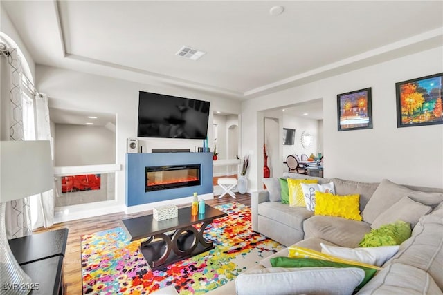 5889 Thistle Meadow Ave, Las Vegas, NV 89139 - living area featuring wood finished floors, a glass covered fireplace, and recessed lighting