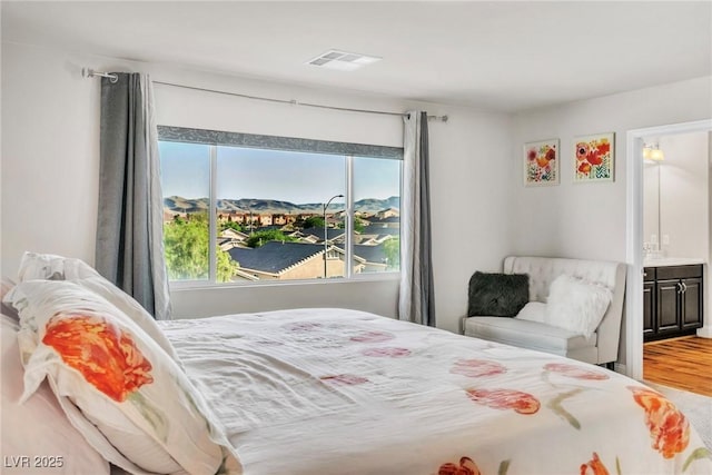 5889 Thistle Meadow Ave, Las Vegas, NV 89139 - bedroom with wood finished floors and ensuite bathroom