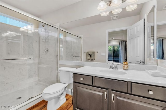 5889 Thistle Meadow Ave, Las Vegas, NV 89139 - bathroom with vanity, a stall shower, and wood finished floors