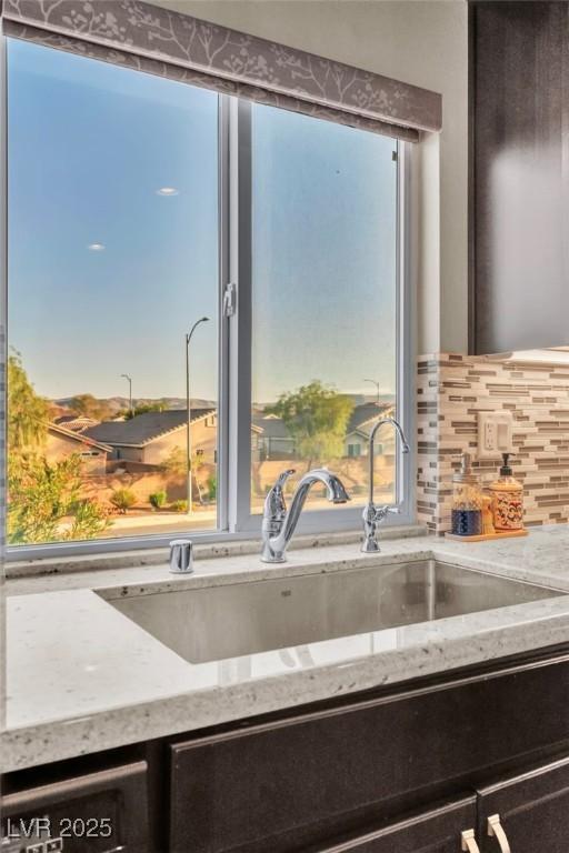 5889 Thistle Meadow Ave, Las Vegas, NV 89139 - kitchen view of light stone counters and backsplash