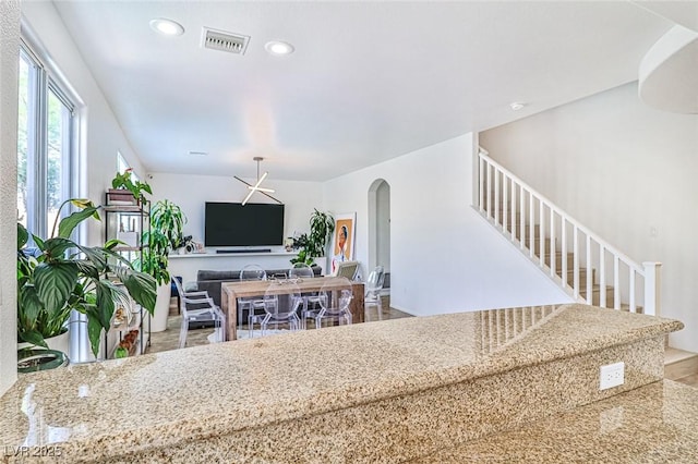 10667 Olympic Pine Dr, Las Vegas, NV 89135 - living room featuring arched walkways, stairs, and recessed lighting