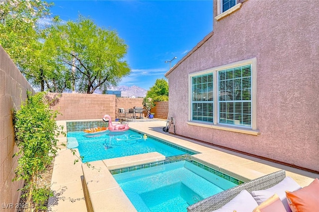 10667 Olympic Pine Dr, Las Vegas, NV 89135 - view of pool featuring a patio area, a fenced backyard, and a pool with connected hot tub