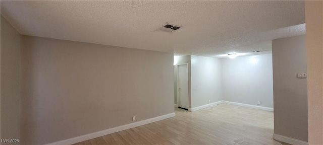 3151 Soaring Gulls Dr Unit 1074, Las Vegas, NV 89128 - empty room featuring light wood finished floors, a textured ceiling, and baseboards