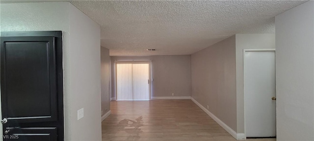 3151 Soaring Gulls Dr Unit 1074, Las Vegas, NV 89128 - hall with light wood-type flooring, a textured ceiling, and baseboards