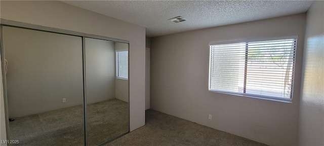 3151 Soaring Gulls Dr Unit 1074, Las Vegas, NV 89128 - unfurnished bedroom featuring carpet, a closet, and a textured ceiling