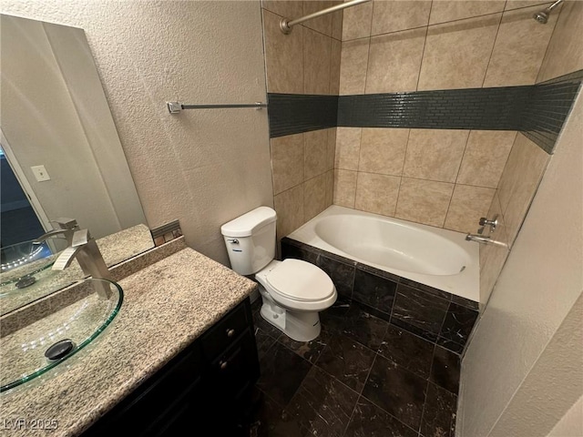 3151 Soaring Gulls Dr Unit 1074, Las Vegas, NV 89128 - bathroom featuring tiled shower / bath, a textured wall, toilet, and vanity