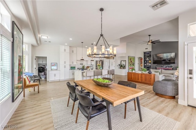 3028 Treesdale Dr, Las Vegas, NV 89134 - dining space with washer / clothes dryer, a chandelier, light wood-style flooring, a ceiling fan, and baseboards