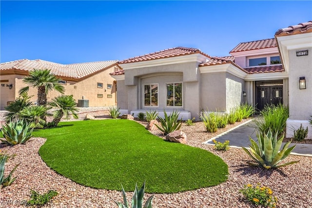 3028 Treesdale Dr, Las Vegas, NV 89134 - mediterranean / spanish-style house with stucco siding, a front lawn, a tile roof, and central air condition unit